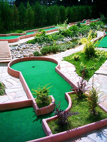 Outdoor miniature golf course in a planted garden