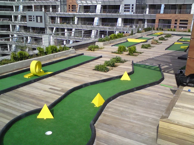Portable miniature golf course with metal obstacles